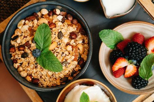 a table topped with bowls of food with fruit and yogurt at Hilton Vienna Plaza in Vienna