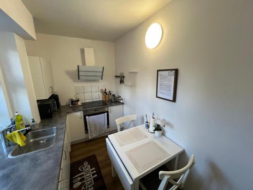 a kitchen and dining room with a table and chairs at Casa de Rainer Copenhagen Room 8 in Copenhagen