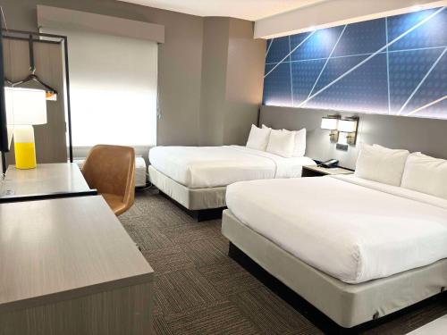 a hotel room with two beds and a desk at Comfort Inn Marietta-Atlanta near Ballpark-Galleria in Marietta