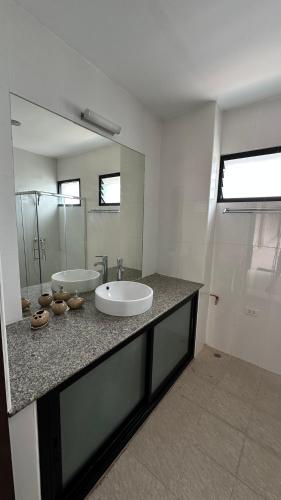 a bathroom with two sinks and a large mirror at Apartment in Koh Samui