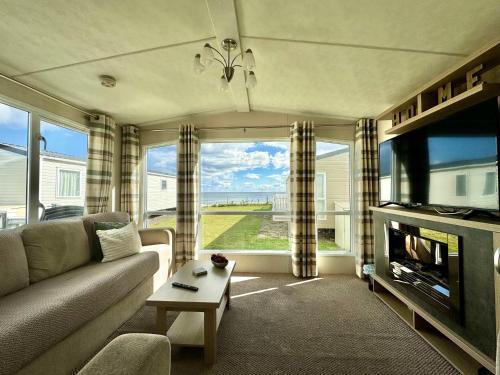 a living room with a couch and a large window at Property S0Ld in Newcastle upon Tyne