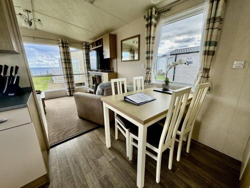 a kitchen and dining room with a table and chairs at Property S0Ld in Newcastle upon Tyne