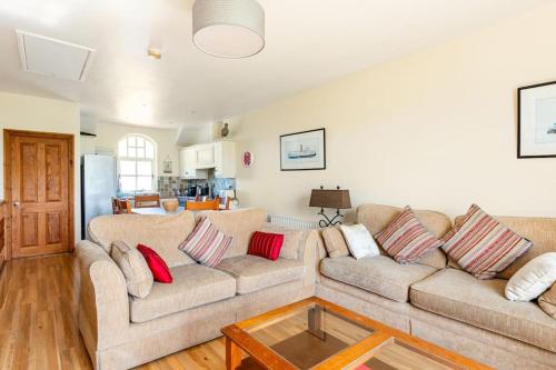 a living room with two couches and a coffee table at 10 Ballaghmore Cottages in Portballintrae