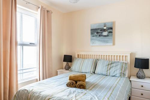 a bedroom with a bed with a towel on it at 10 Ballaghmore Cottages in Portballintrae