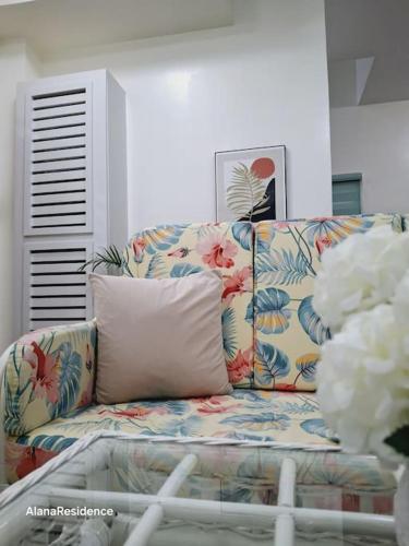 a couch with a pillow in a living room at Vacation Home near Panglao Airport and White Sand Beaches in Biking