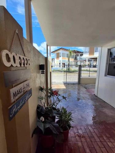 a entrance to a building with potted plants and a sign at Vacation Home near Panglao Airport and White Sand Beaches in Biking