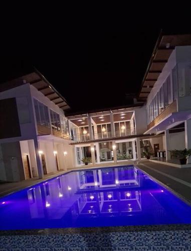 a large swimming pool with blue lights in a house at Vacation Home near Panglao Airport and White Sand Beaches in Biking