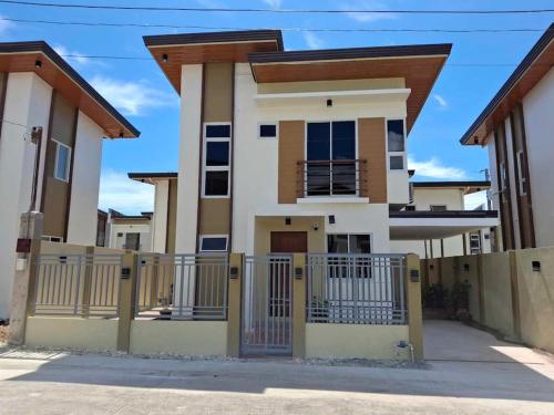 a house with a gate in front of it at Vacation Home near Panglao Airport and White Sand Beaches in Biking