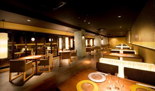 a dining room with tables and chairs in a restaurant at Aura Tachibana in Hakone