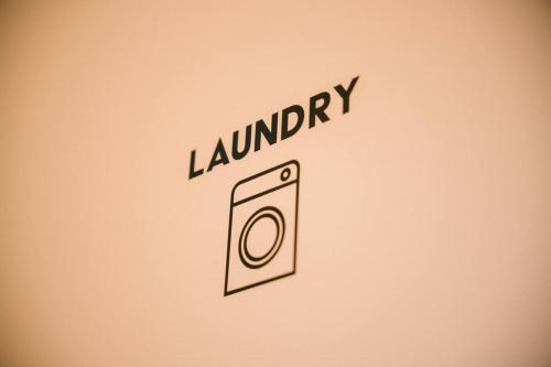 a sign that says laundry with a picture of a toilet at 糸島STAYｘCafe 海のみちひき-小富士あたり- in Itoshima