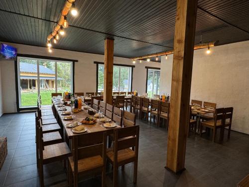 a dining room with a long table and chairs at Відпочинковий комплекс Біла Кобила in Verkhovyna