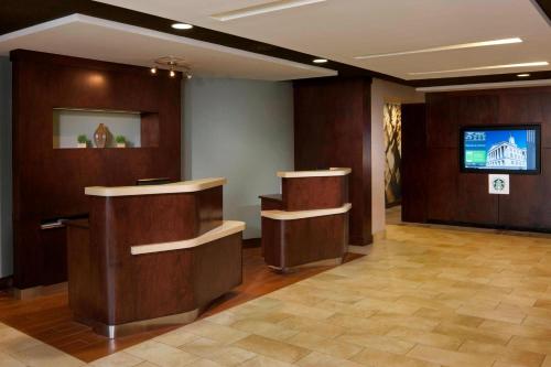 a lobby with a waiting room with a tv in it at Courtyard by Marriott Jackson in Jackson