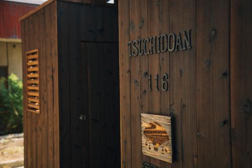 a wooden building with a sign on the side of it at 尾道土堂庵 Onomichi TSUCHIDOAN supported by COCOSTAY in Onomichi