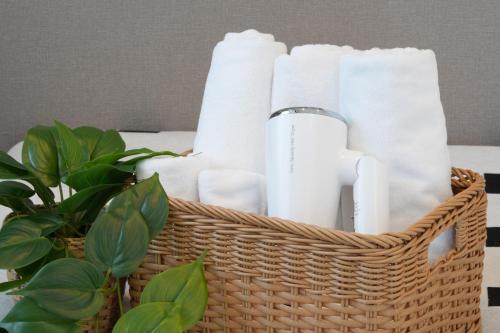 a basket full of toilet paper and a plant at Sanctuary Residence TennojiKouenMinami in Osaka