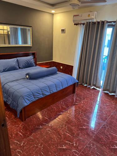 a bedroom with a bed with a marble floor at S & D Guesthouse in Kampot