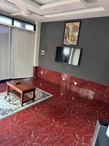 a room with a red marble floor and a table at S & D Guesthouse in Kampot
