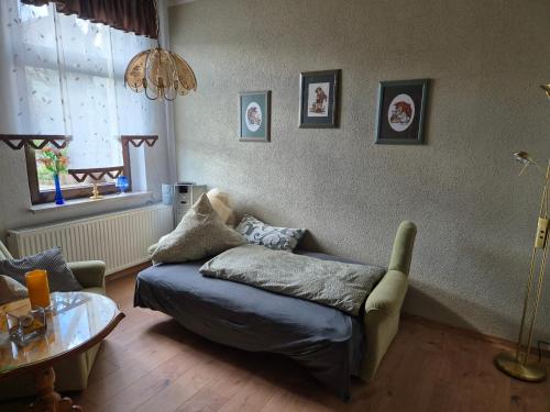 a living room with a couch and a table at Ferienwohnung am Hammerberg in Schönheide