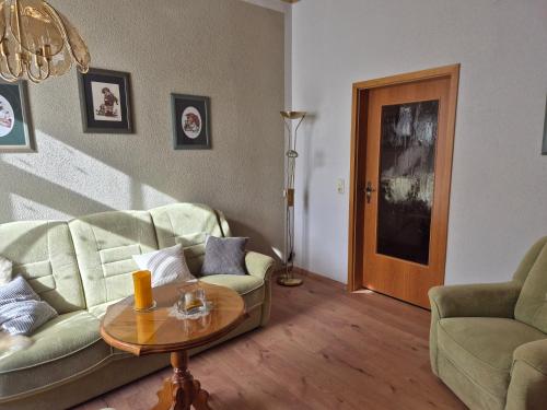 a living room with a couch and a table at Ferienwohnung am Hammerberg in Schönheide