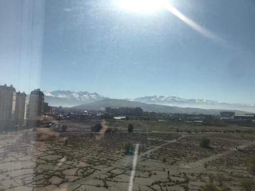 a view of a city with mountains in the background at Уютный уголок в престижной части города 3 in Bishkek