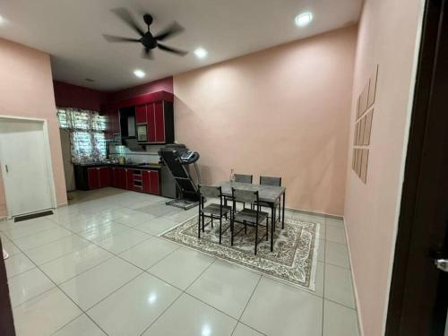 d'une salle à manger avec une table et un ventilateur de plafond. dans l'établissement Norelsya Homestay Bemban Melaka, à Bemban