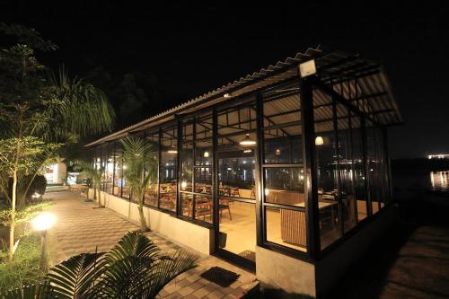 a building with glass windows at night at RiverView Tent Resort in Kevadia