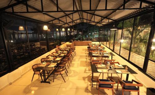 a large dining room with tables and chairs at RiverView Tent Resort in Kevadia