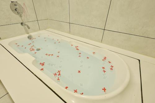 a white bath tub with red stars on it at RiverView Tent Resort in Kevadia