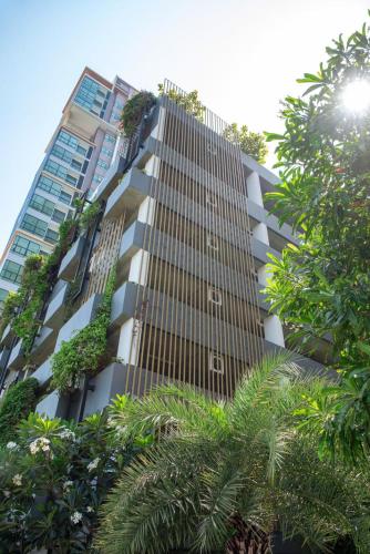 a tall building with plants on the side of it at Suvarnabhumi Airport , Bangkok , Sukumvit ,Bts Ekamai-Bangna in Amphoe Phra Khanong