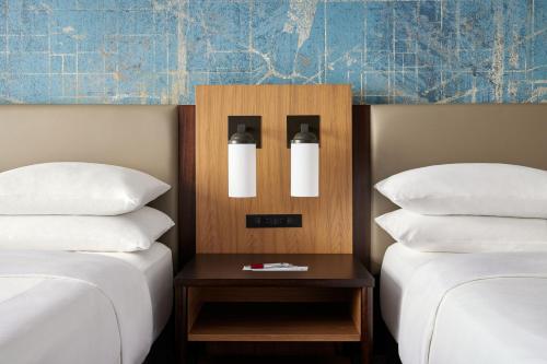 two beds with white pillows and a nightstand between them at Washington Marriott at Metro Center in Washington
