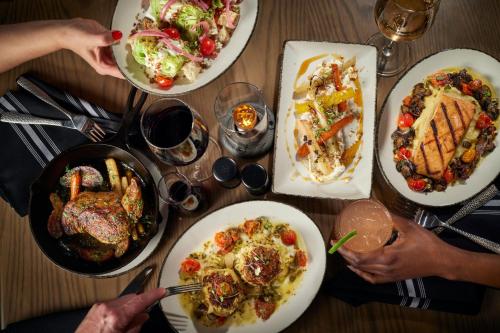 a group of people sitting around a table with plates of food at Washington Marriott at Metro Center in Washington