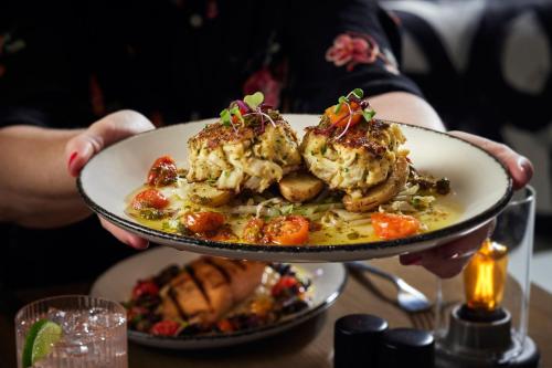 a person holding a plate of food on a table at Washington Marriott at Metro Center in Washington