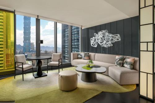 a living room with a couch and a table at W Taipei in Taipei