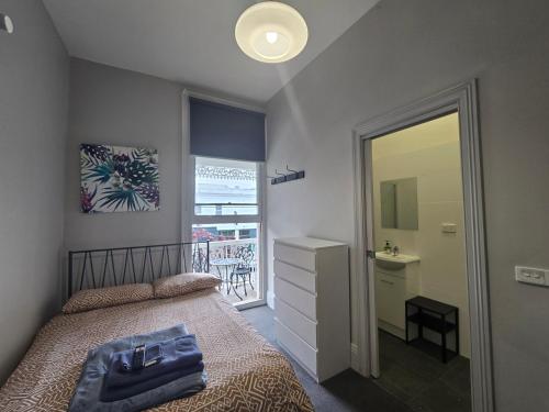 a bedroom with a bed and a mirror at 50 Green St Windsor in Melbourne