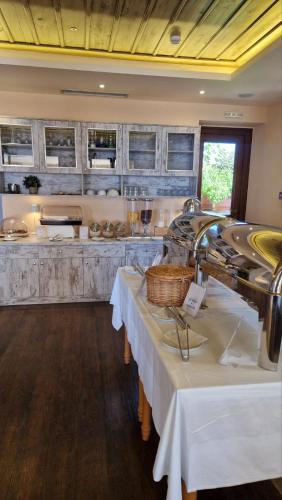 a kitchen with two tables in a room at Castello Antico Hotel in Gythio