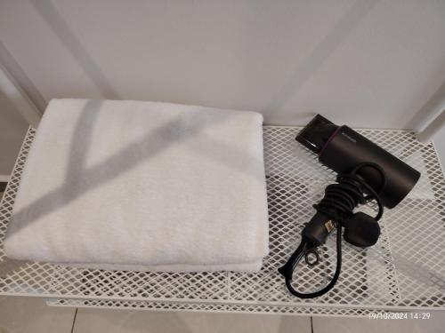 a camera sitting on a table next to a towel at Austin Melaka in Kampong Sungai Putat