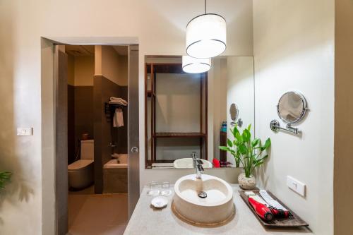 a bathroom with a sink and a mirror at Bayon Modern Residence in Siem Reap