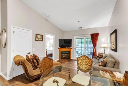 a living room with a couch and chairs and a fireplace at Grand Wood Suites - 3rd Floor Back Side Penthouse Suite 307 in Nashville