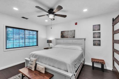 a bedroom with a bed and a ceiling fan at Grand Wood Suites - 2nd Floor Front Side Signature Suite 201 in Nashville