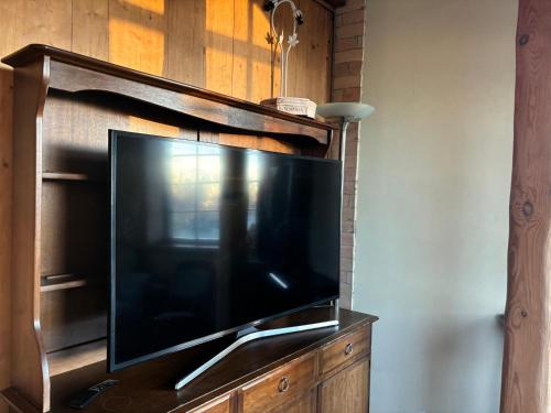 a large flat screen tv on a wooden entertainment center at Villa Vesta in Dolnāja