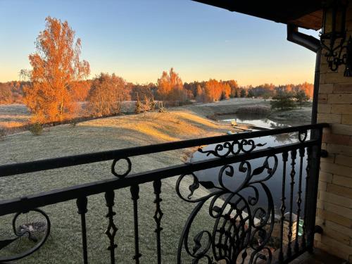 a balcony with a view of a field and trees at Villa Vesta in Dolnāja
