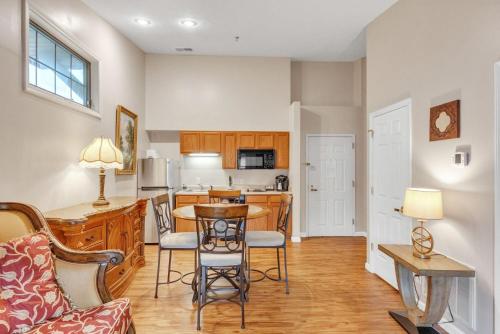 a kitchen and living room with a table and chairs at Grand Wood Suites - 3rd Floor Back Side Corner Penthouse Suite 305 in Nashville