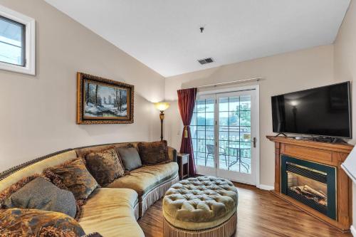 a living room with a couch and a fireplace at Grand Wood Suites - 3rd Floor Front Side Corner Penthouse Suite 301 in Nashville
