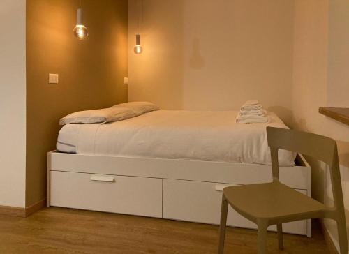 a bed with a dresser and a chair in a room at Oltrebosco Casa Vacanze in Valfabbrica