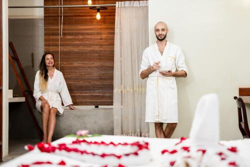 a man and a woman standing in front of a mirror at Bayon Modern Residence in Siem Reap