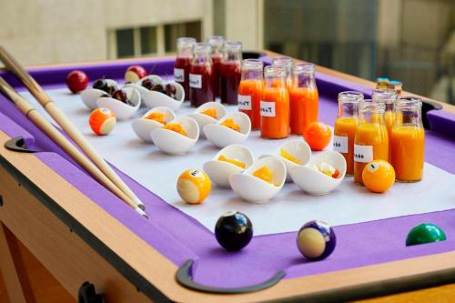 a billiard table with eggs and bottles of juice at London Marriott Hotel County Hall in London