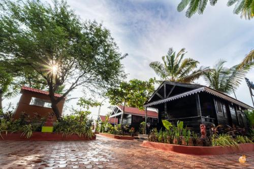 a building with a cobblestone street in front of it at TT Beach Cottages in Candolim