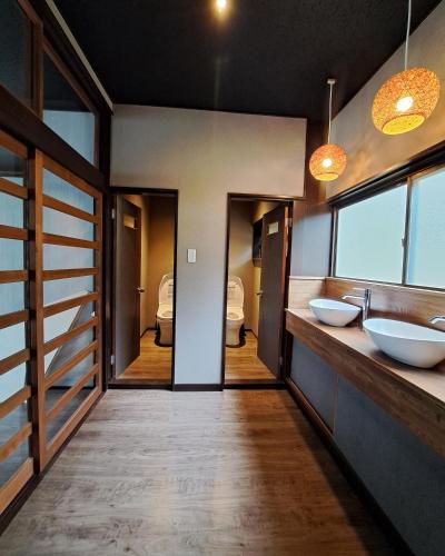 a bathroom with two sinks and two mirrors at Yuki Lodge Myoko in Myoko