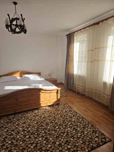 a bedroom with a bed and a chandelier at Casa Stely in Râşnov
