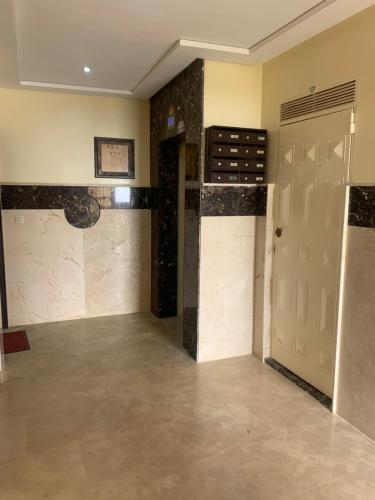 a large room with a door and a tile floor at Achakar Hills appartement in Jbila