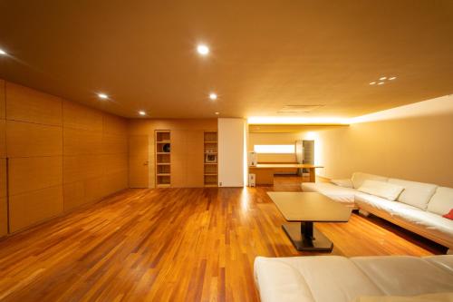 a living room with a couch and a table at Azabu Modern House The Tokyo Tower can be seen from the villa 500m2 in Tokyo
